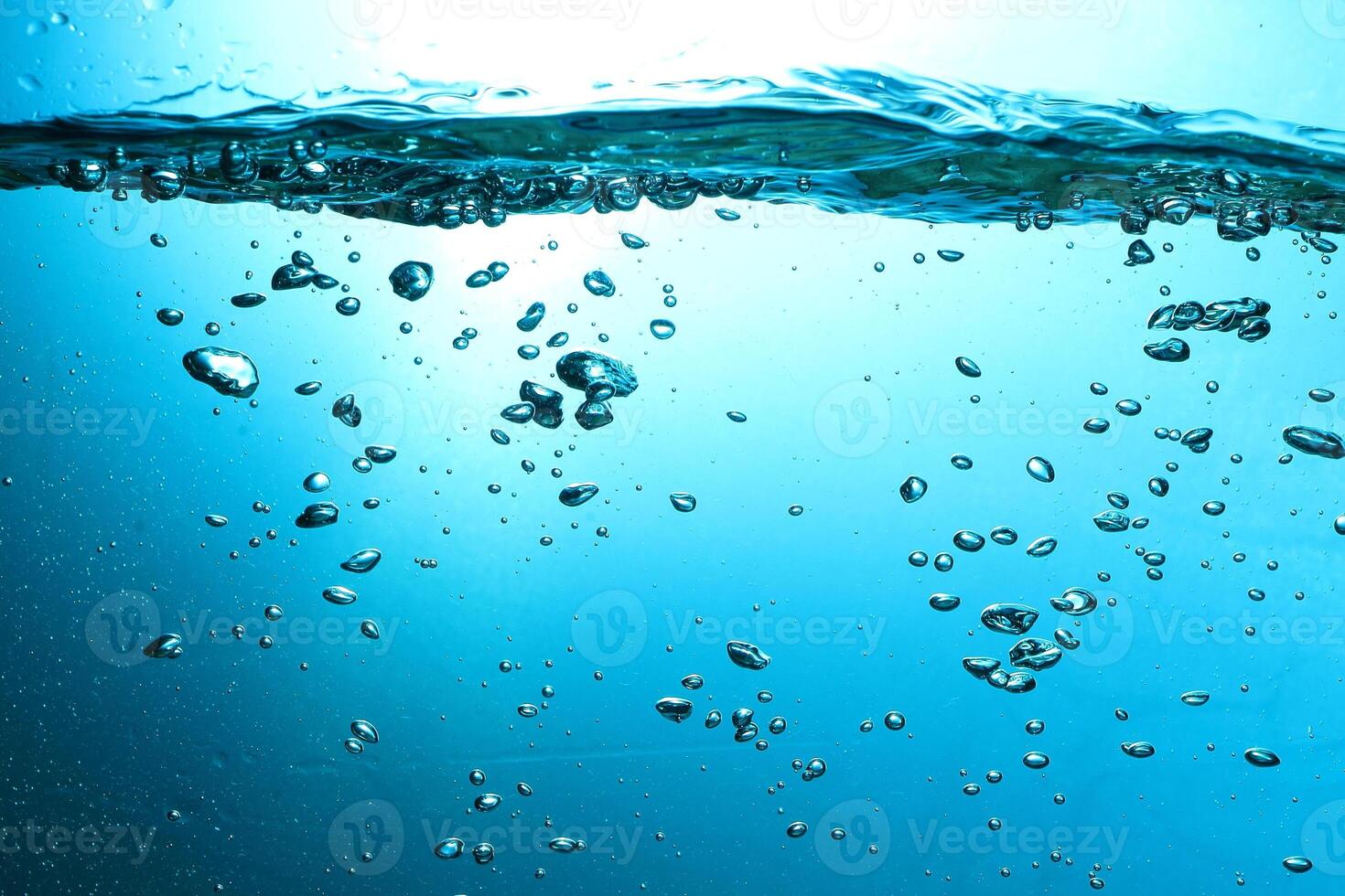 Fresh Water With Underwater Bubbles Texture on a Blue Background Close-up Abstract Liquid Bubbles Aqua Design Wallpaper photo