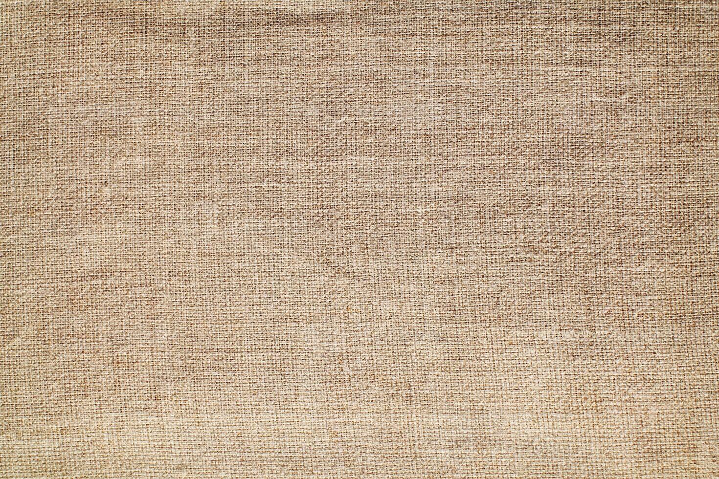 Natural Linen Material Textile Canvas Fabric Texture Background Close-up Detail of Fabric Natural Color Hemp Material Pattern Design Wallpaper. Can be Used as Background or For Graphic Design photo