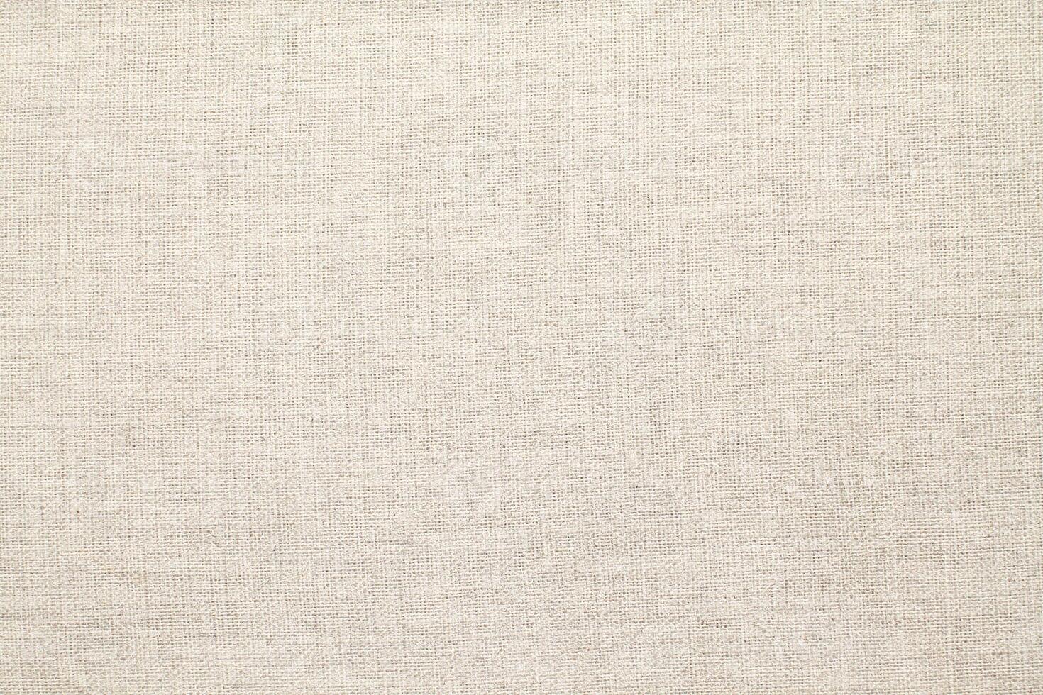 Natural Linen Material Textile Canvas Fabric Texture Background Close-up Detail of Fabric Natural Color Hemp Material Pattern Design Wallpaper. Can be Used as Background or For Graphic Design photo