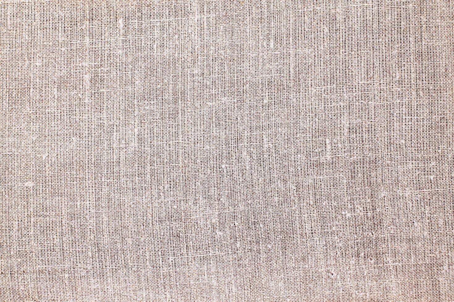Natural Linen Material Textile Canvas Fabric Texture Background Close-up Detail of Fabric Natural Color Hemp Material Pattern Design Wallpaper. Can be Used as Background or For Graphic Design photo