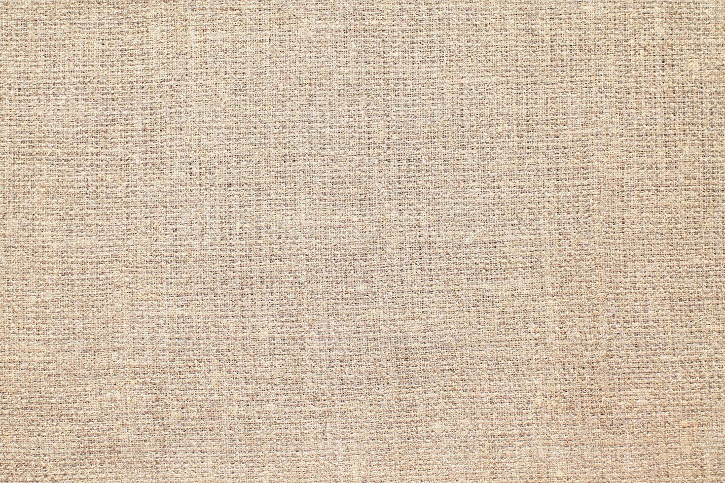 Natural Linen Material Textile Canvas Fabric Texture Background Close-up Detail of Fabric Natural Color Hemp Material Pattern Design Wallpaper. Can be Used as Background or For Graphic Design photo