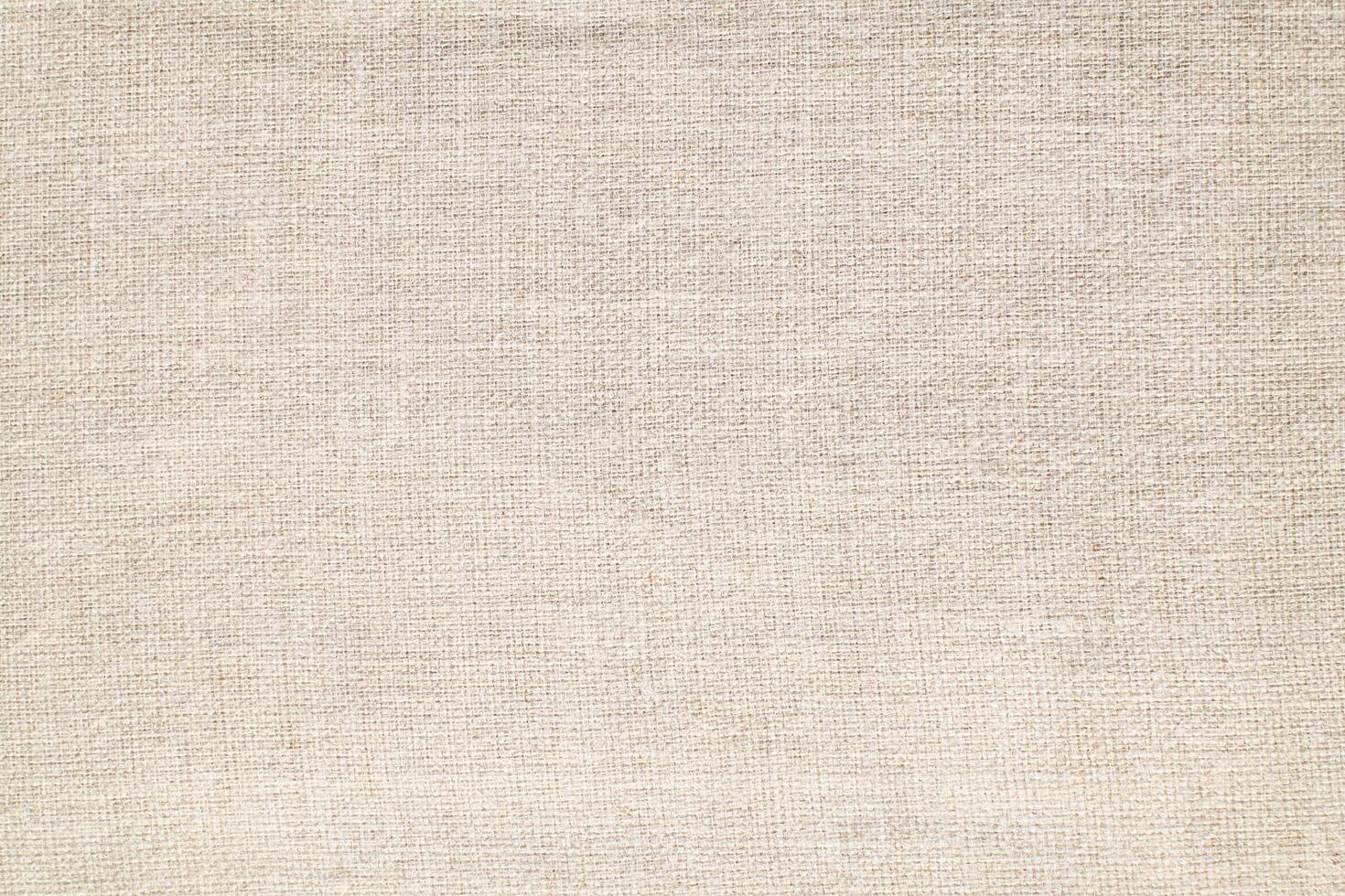 Natural Linen Material Textile Canvas Fabric Texture Background Close-up Detail of Fabric Natural Color Hemp Material Pattern Design Wallpaper. Can be Used as Background or For Graphic Design photo