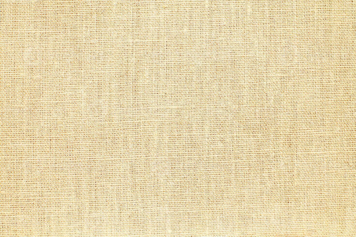 Natural Linen Material Textile Canvas Fabric Texture Background Close-up Detail of Fabric Natural Color Hemp Material Pattern Design Wallpaper. Can be Used as Background or For Graphic Design photo
