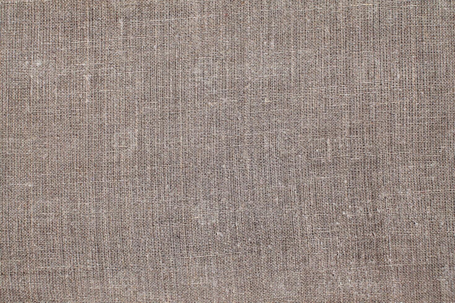 Natural Linen Material Textile Canvas Fabric Texture Background Close-up Detail of Fabric Natural Color Hemp Material Pattern Design Wallpaper. Can be Used as Background or For Graphic Design photo