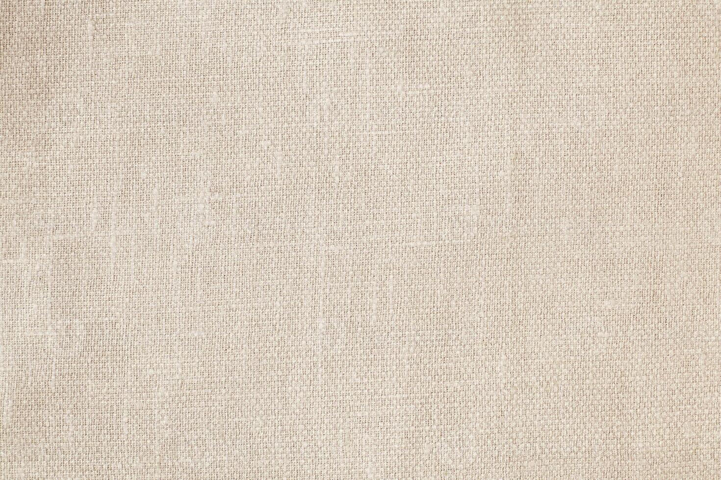 Natural Linen Material Textile Canvas Fabric Texture Background Close-up Detail of Fabric Natural Color Hemp Material Pattern Design Wallpaper. Can be Used as Background or For Graphic Design photo