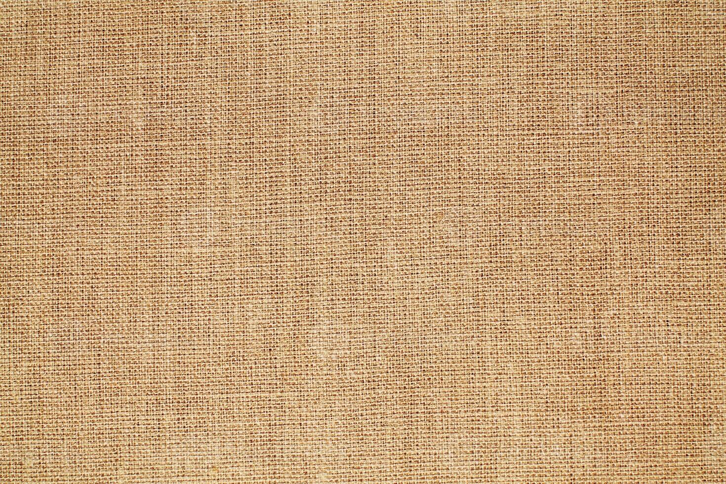Natural Linen Material Textile Canvas Fabric Texture Background Close-up Detail of Fabric Natural Color Hemp Material Pattern Design Wallpaper. Can be Used as Background or For Graphic Design photo
