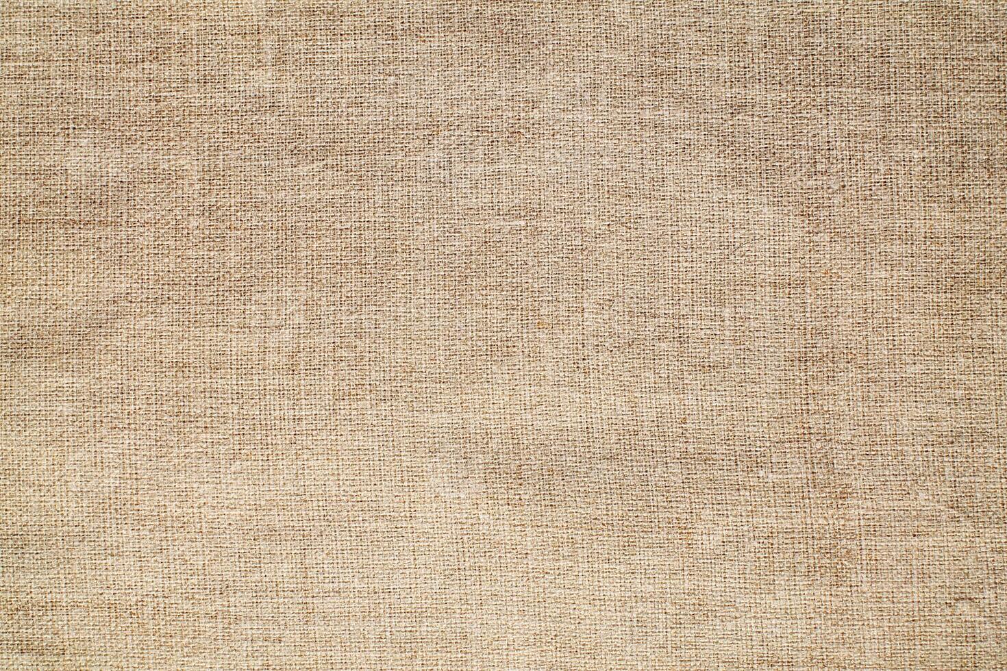 Natural Linen Material Textile Canvas Fabric Texture Background Close-up Detail of Fabric Natural Color Hemp Material Pattern Design Wallpaper. Can be Used as Background or For Graphic Design photo