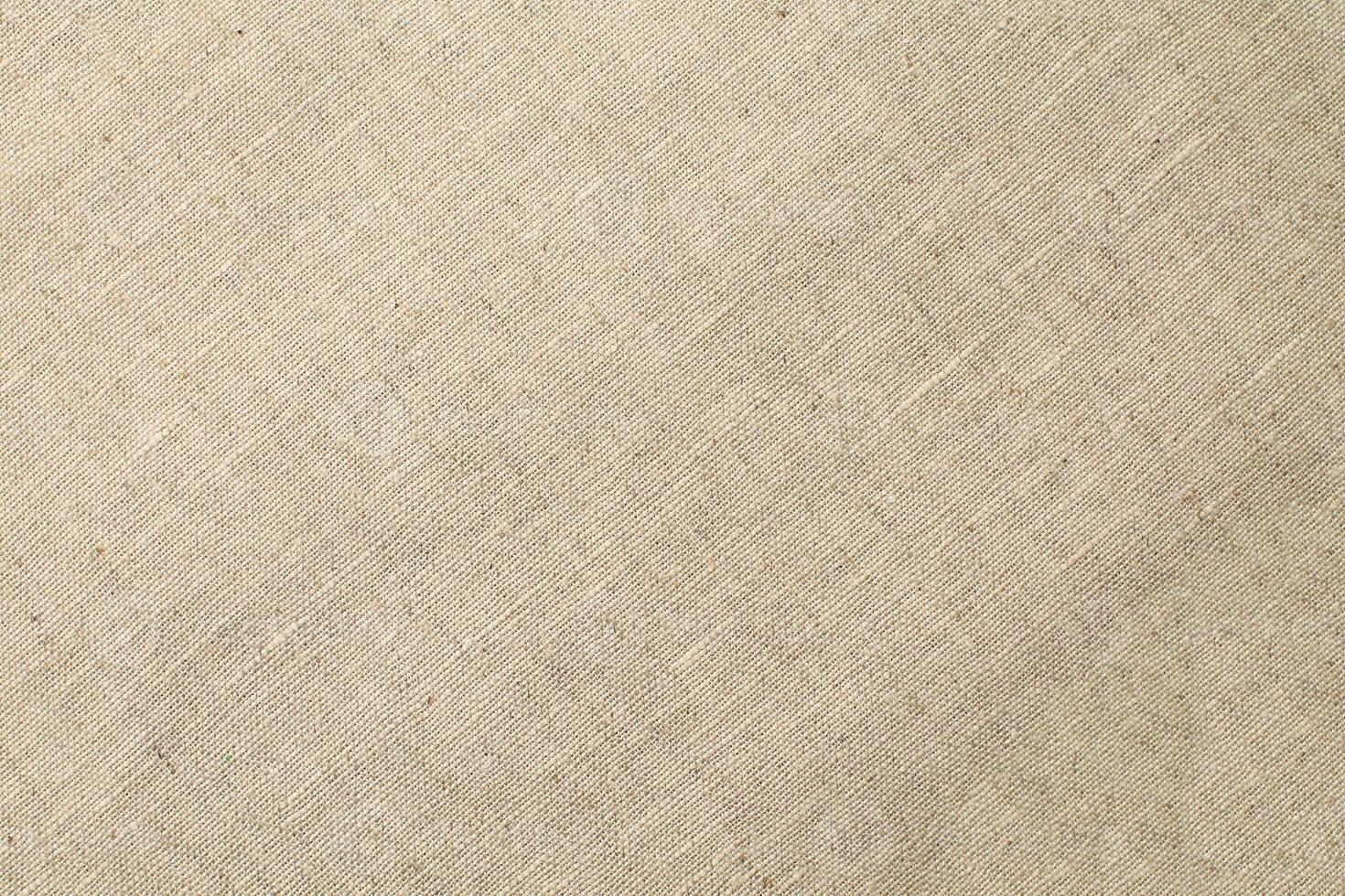 Natural Linen Material Textile Canvas Fabric Texture Background Close-up Detail of Fabric Natural Color Hemp Material Pattern Design Wallpaper. Can be Used as Background or For Graphic Design photo