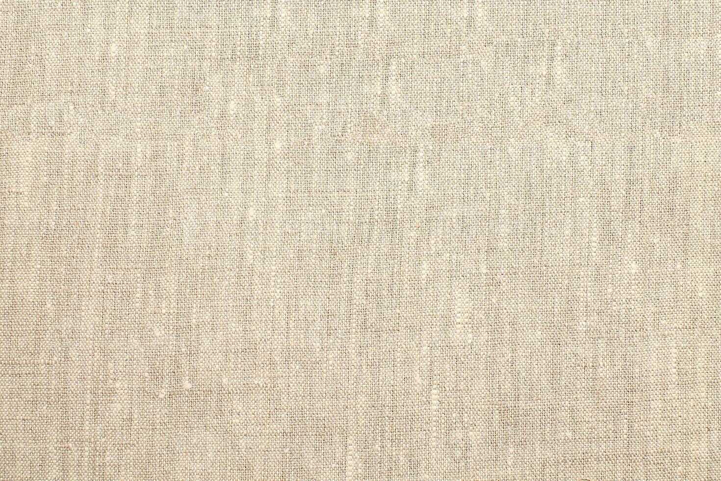 Natural Linen Material Textile Canvas Fabric Texture Background Close-up Detail of Fabric Natural Color Hemp Material Pattern Design Wallpaper. Can be Used as Background or For Graphic Design photo