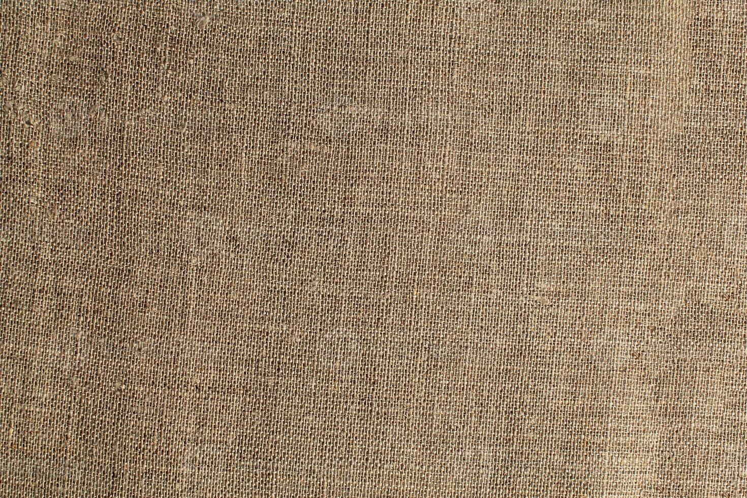 Natural Linen Material Textile Canvas Fabric Texture Background Close-up Detail of Fabric Natural Color Hemp Material Pattern Design Wallpaper. Can be Used as Background or For Graphic Design photo