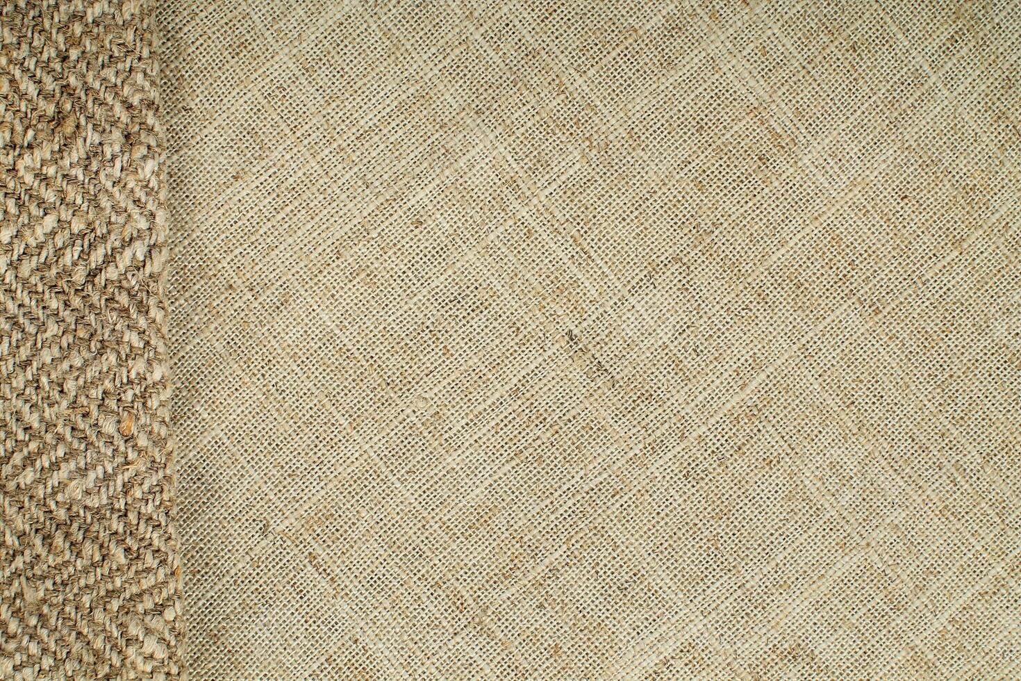 Natural Linen Material Textile Canvas Fabric Texture Background Close-up Detail of Fabric Natural Color Hemp Material Pattern Design Wallpaper. Can be Used as Background or For Graphic Design photo