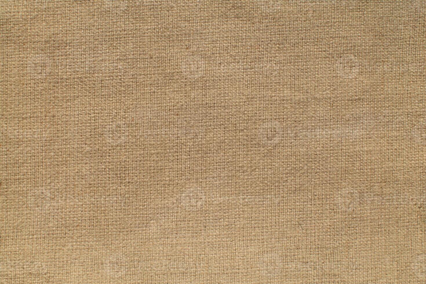 Natural Linen Material Textile Canvas Fabric Texture Background Close-up Detail of Fabric Natural Color Hemp Material Pattern Design Wallpaper. Can be Used as Background or For Graphic Design photo