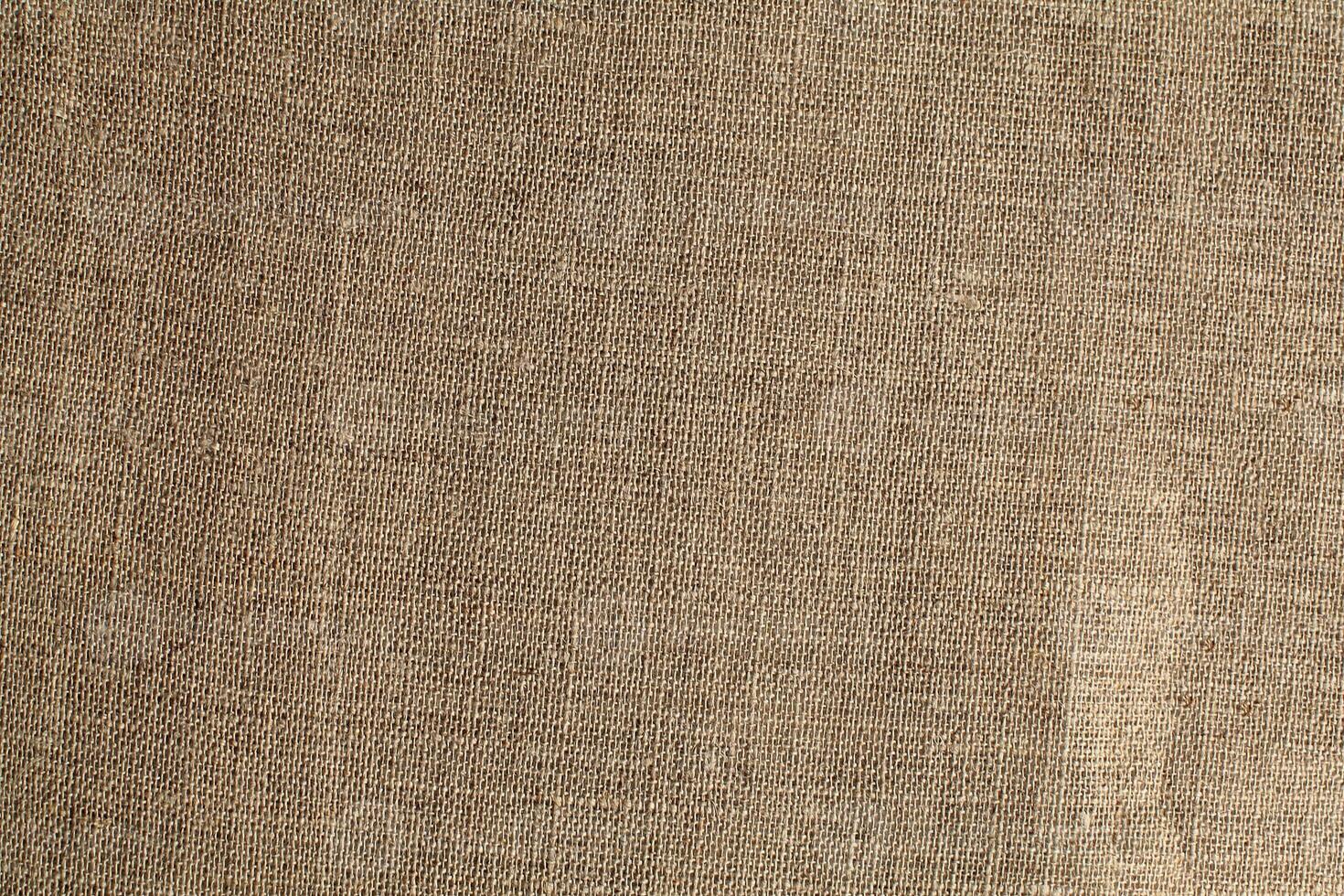 Natural Linen Material Textile Canvas Fabric Texture Background Close-up Detail of Fabric Natural Color Hemp Material Pattern Design Wallpaper. Can be Used as Background or For Graphic Design photo