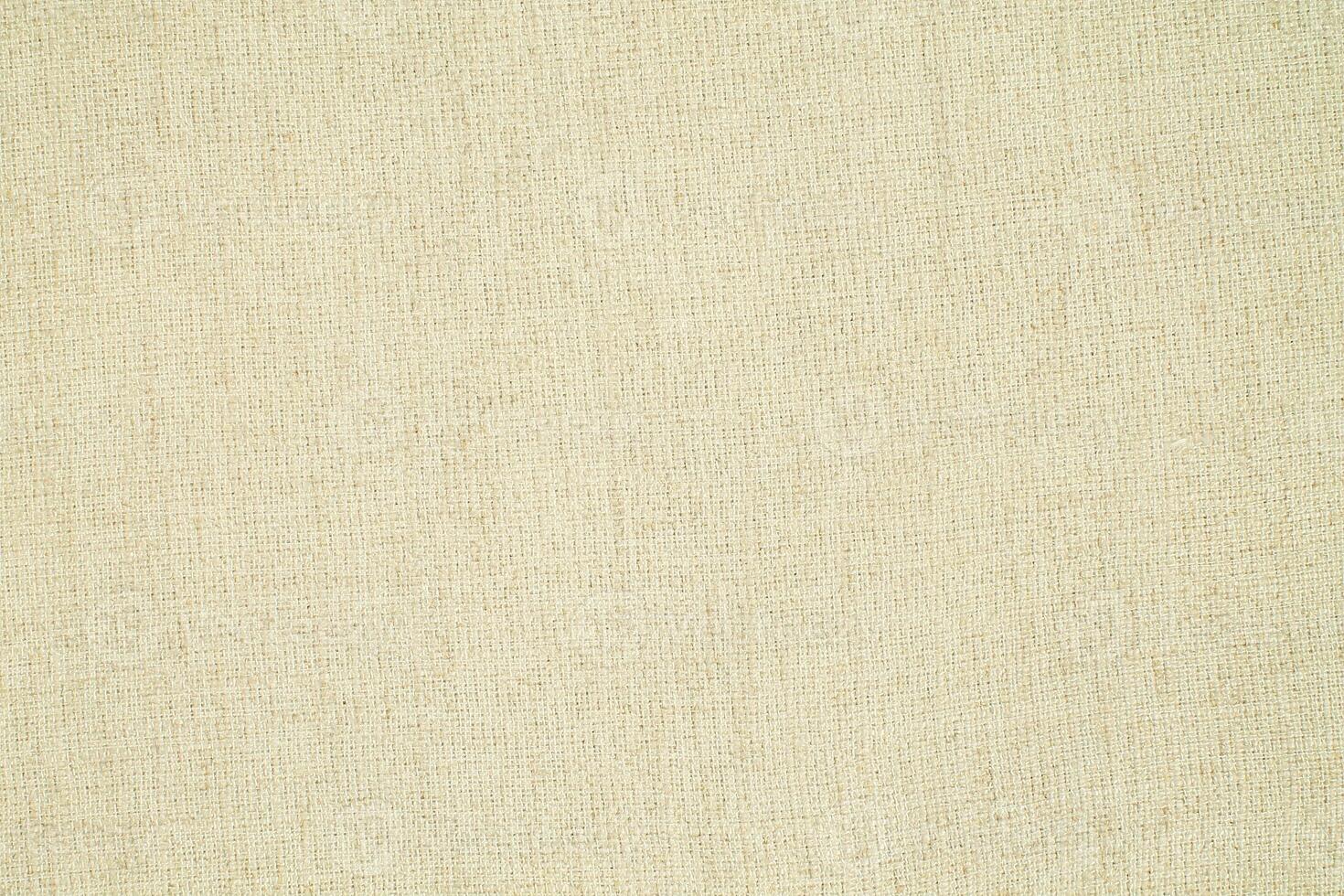 Natural Linen Material Textile Canvas Fabric Texture Background Close-up Detail of Fabric Natural Color Hemp Material Pattern Design Wallpaper. Can be Used as Background or For Graphic Design photo