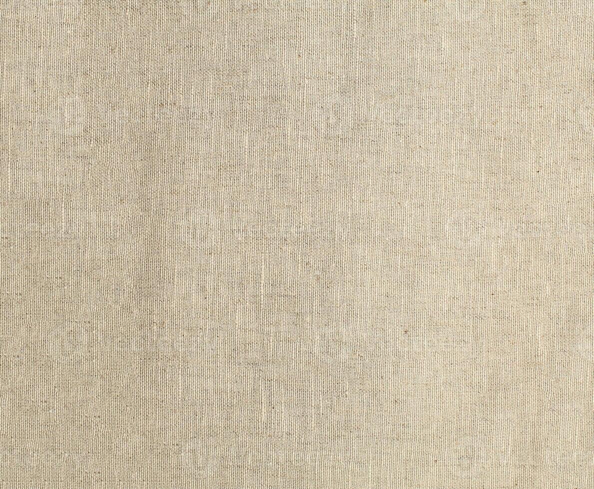 Natural Linen Material Textile Canvas Fabric Texture Background Close-up Detail of Fabric Natural Color Hemp Material Pattern Design Wallpaper. Can be Used as Background or For Graphic Design photo