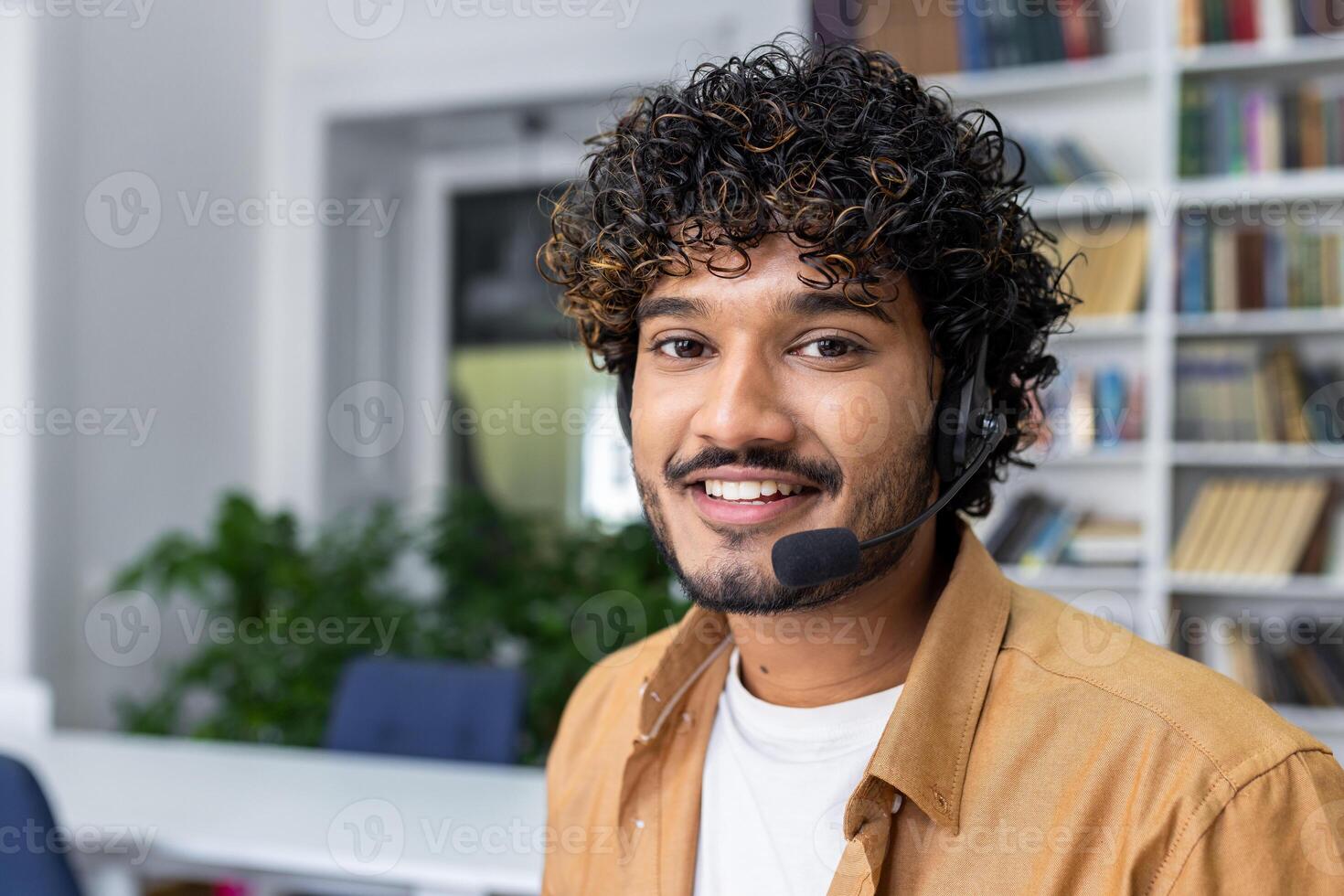 A cheerful customer service representative wearing a headset in a modern office setting. This professional young man exudes friendliness and approachability while ready to assist clients. photo