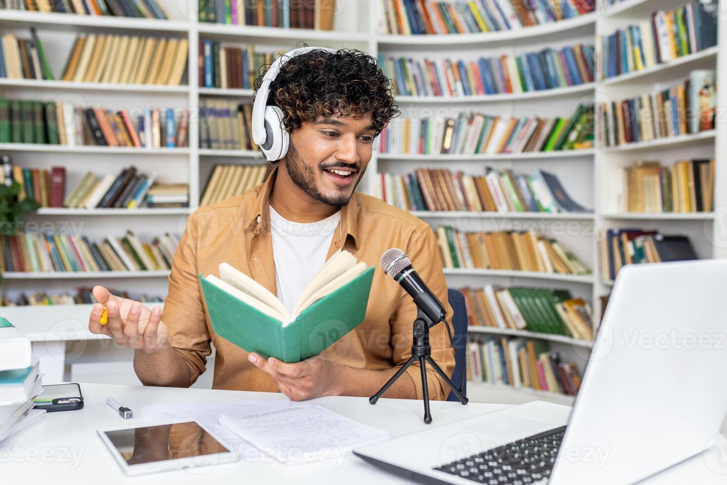 A young male podcaster records in a cozy home studio set against a bookshelf backdrop, evoking a vibe of knowledge and creativity. His engagement with audience is palpable even through visual medium. photo