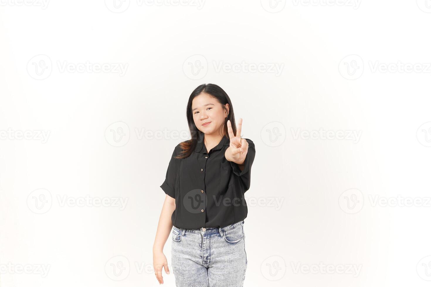 Young Asian woman showing peace sign two finger wearing Black t-shirt and jeans isolated on white background photo