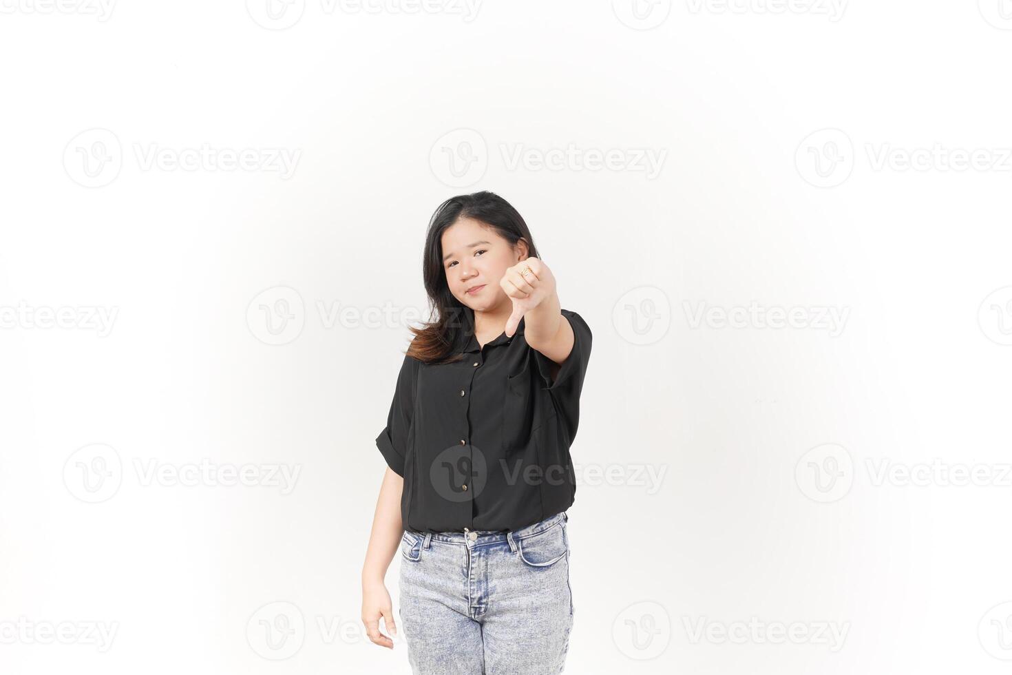 Young Asian woman showing thumbs down wearing Black t-shirt and jeans isolated on white background photo