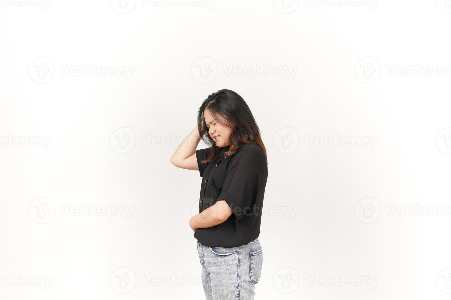 Young Asian woman suffering headache, hand on head wearing Black t-shirt and jeans isolated on white background photo