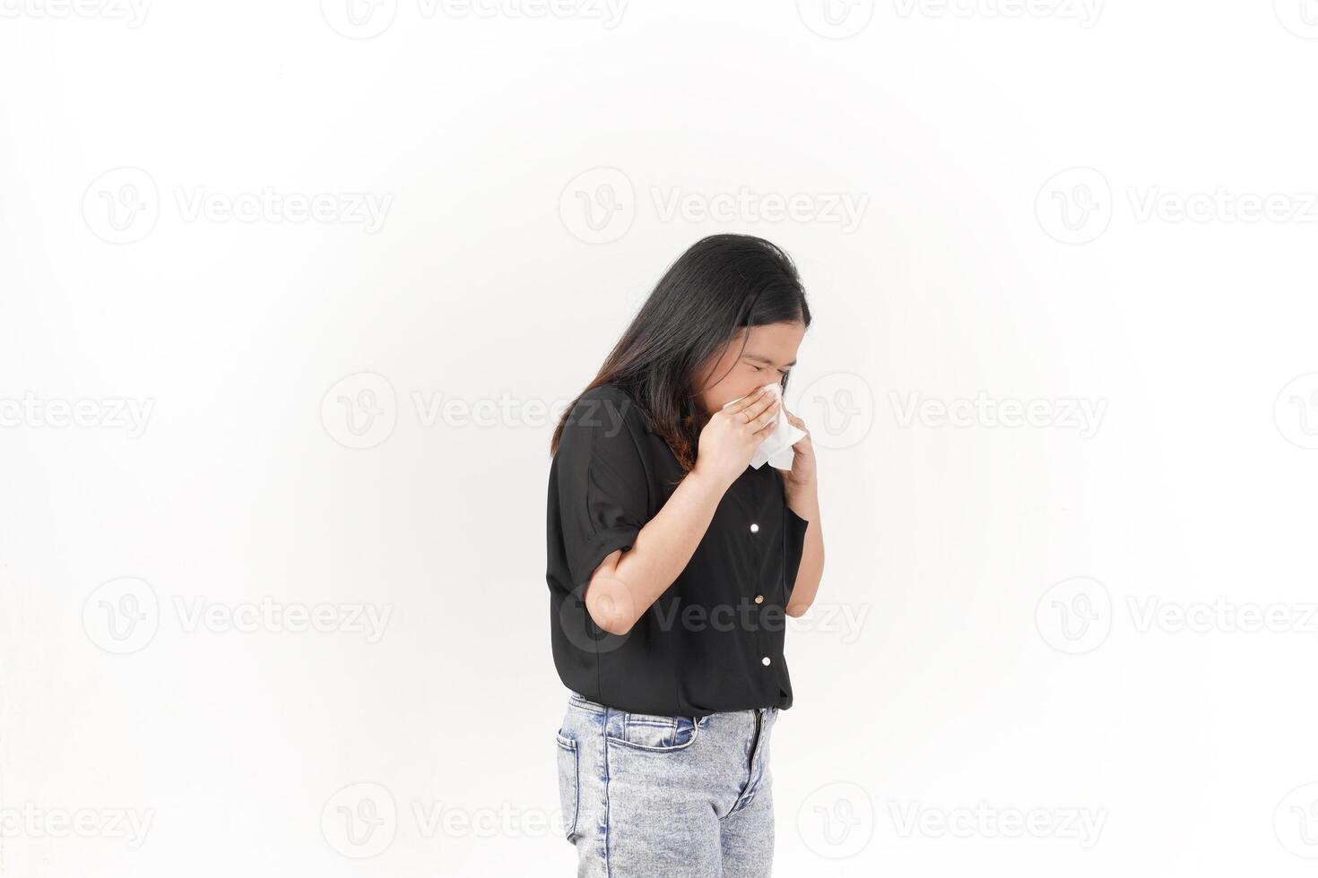 Young Asian woman suffering flu hand holding tissue wearing Black t-shirt and jeans isolated on white background photo