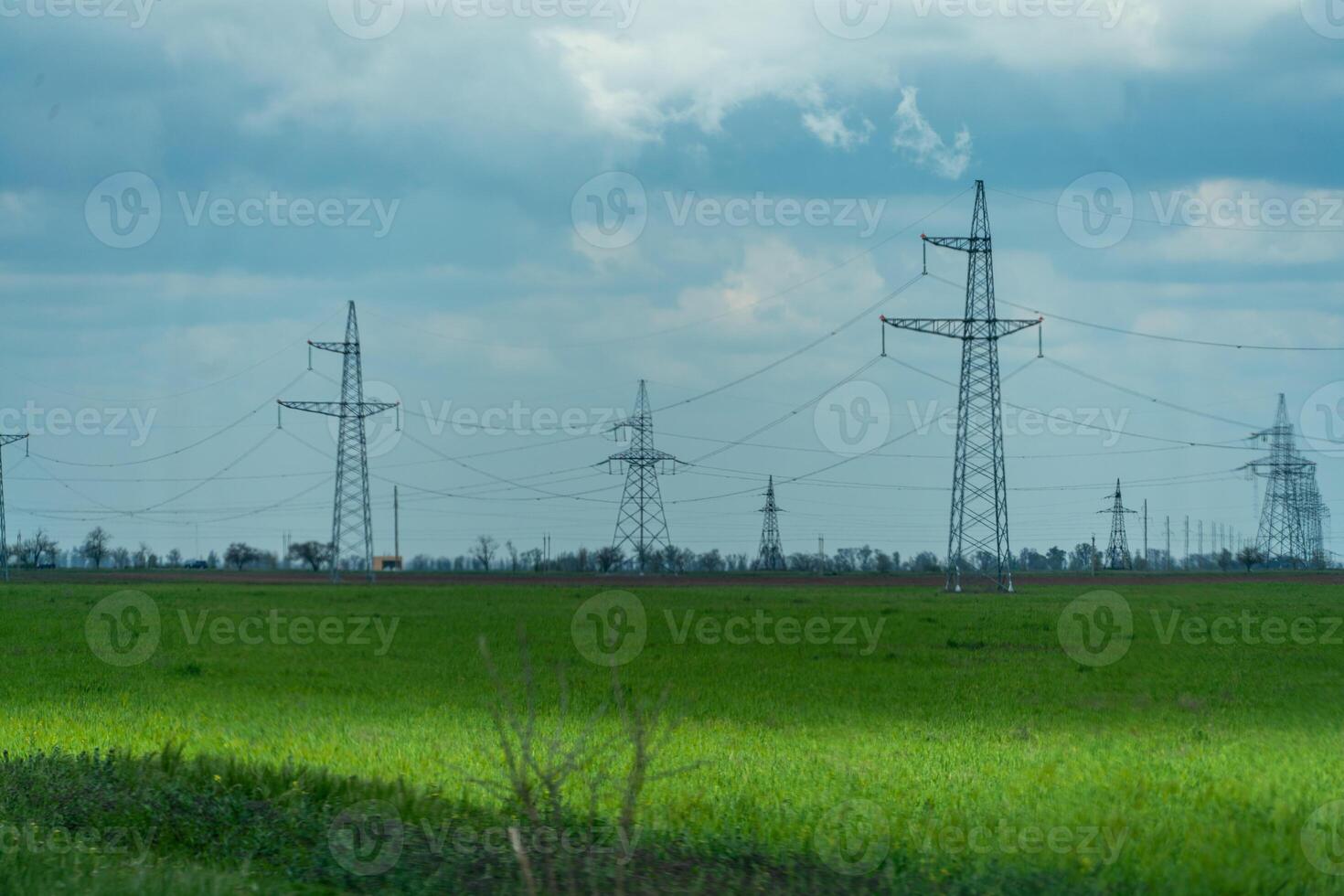 High voltage towers with sky background. Power line support with wires for electricity transmission. High voltage grid tower with wire cable at distribution station. Energy industry, energy saving photo