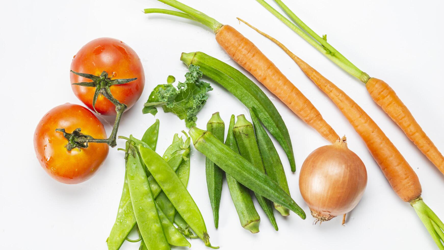 a variety of vegetables including carrots, beans, and tomatoes photo