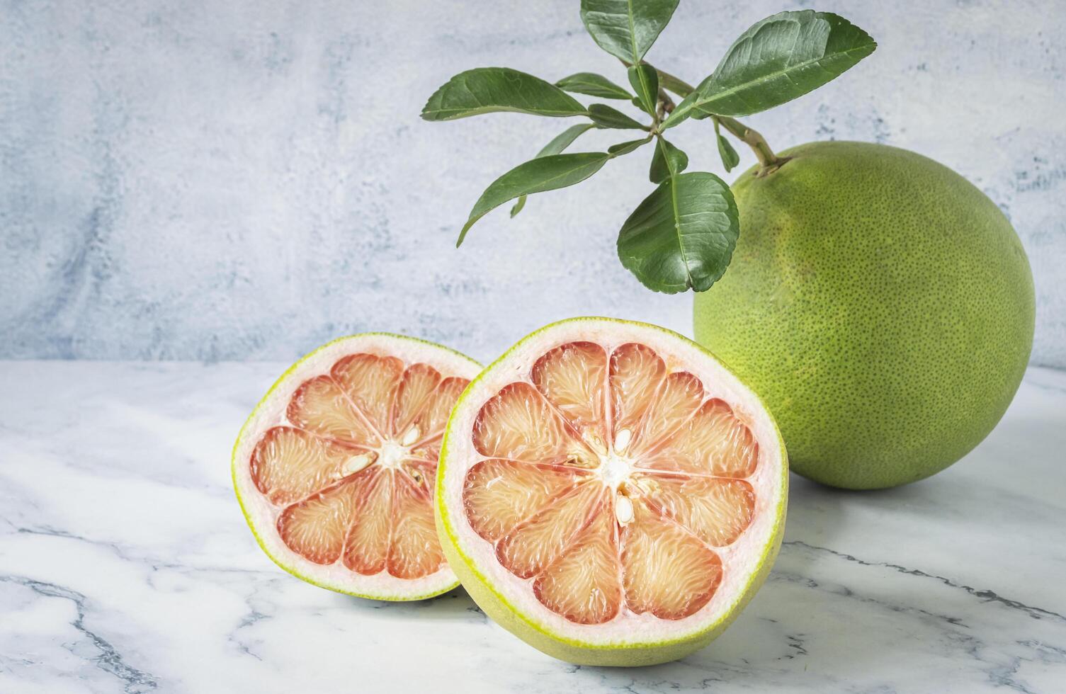 pomelo and a plant on a table photo