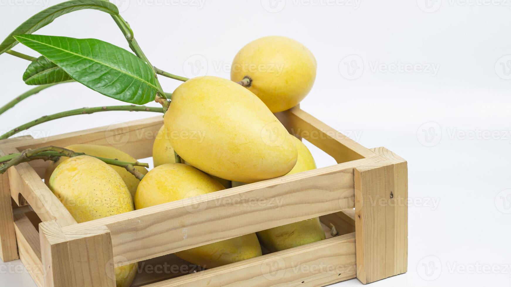 a wooden crate with several mangoes in it photo