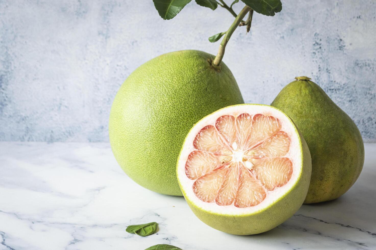 a pomelo and a half of a grapefruit photo
