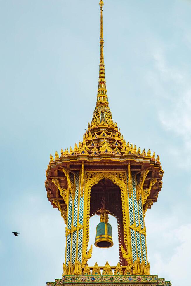 A golden Thai temple roof in Bangkok, showcasing intricate architecture and traditional, Wat Phra Kaew, Thailand. photo