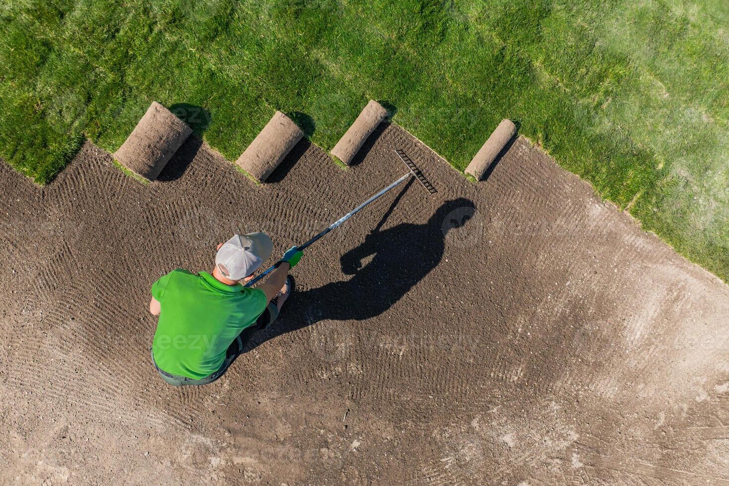 Man Installing Grass Turfs on a Golf Course Aerial View. photo