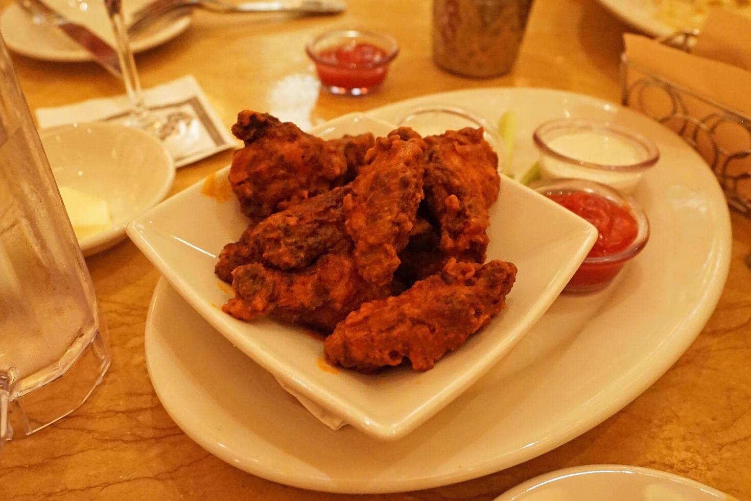 Close up battered and deep fried chicken wings photo