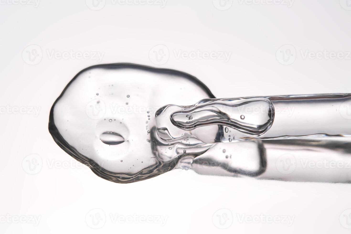 Pipette with cosmetic gel or serum close-up. photo