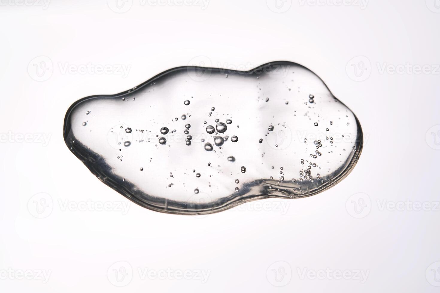 A smear of cosmetic gel close-up on a gray background. Appetizing texture with bubbles. photo