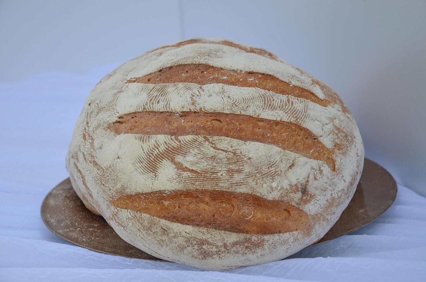 Round well-baked bread - a symbol of hospitality photo