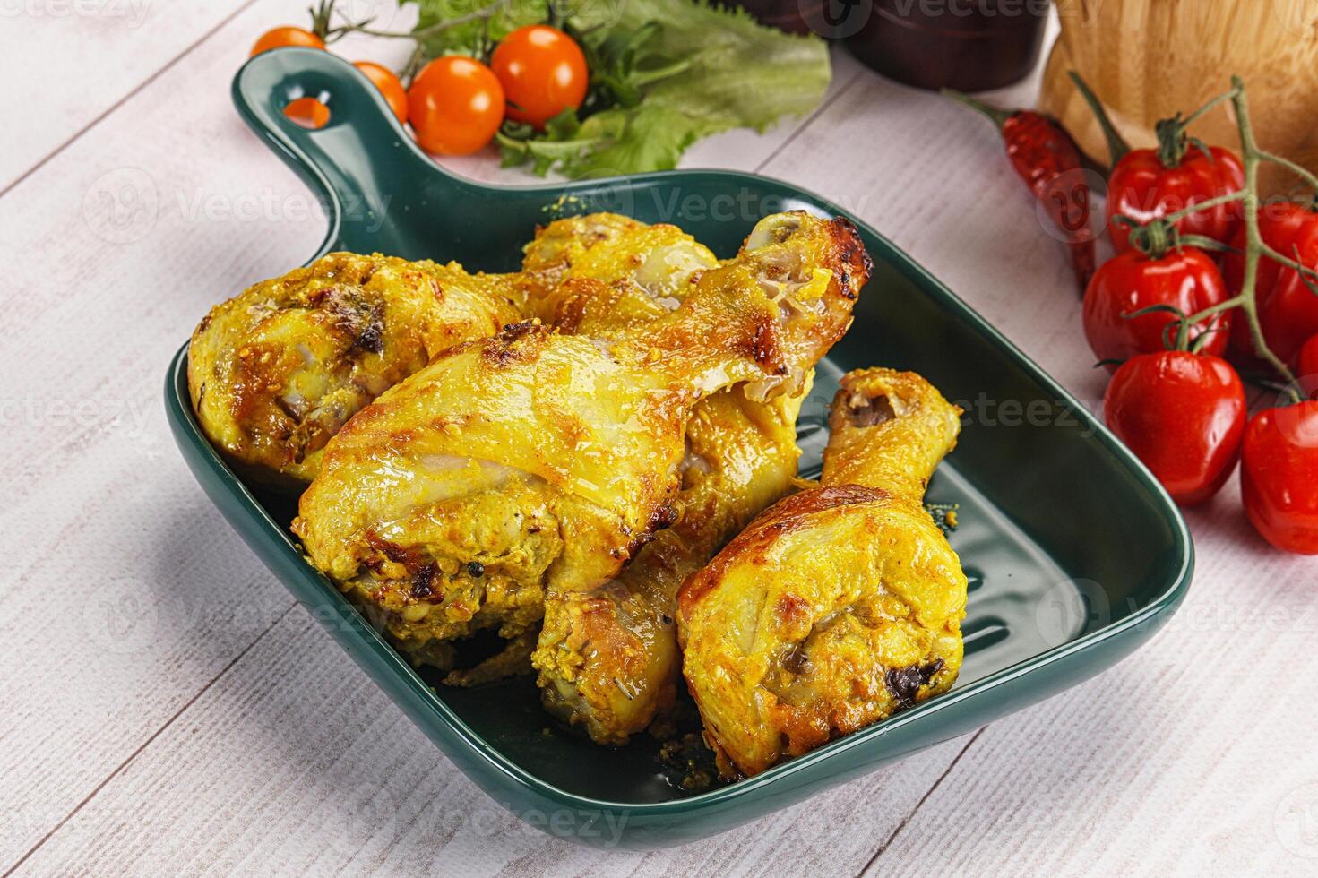 Roasted Chicken leg drumsticks with curry sauce photo