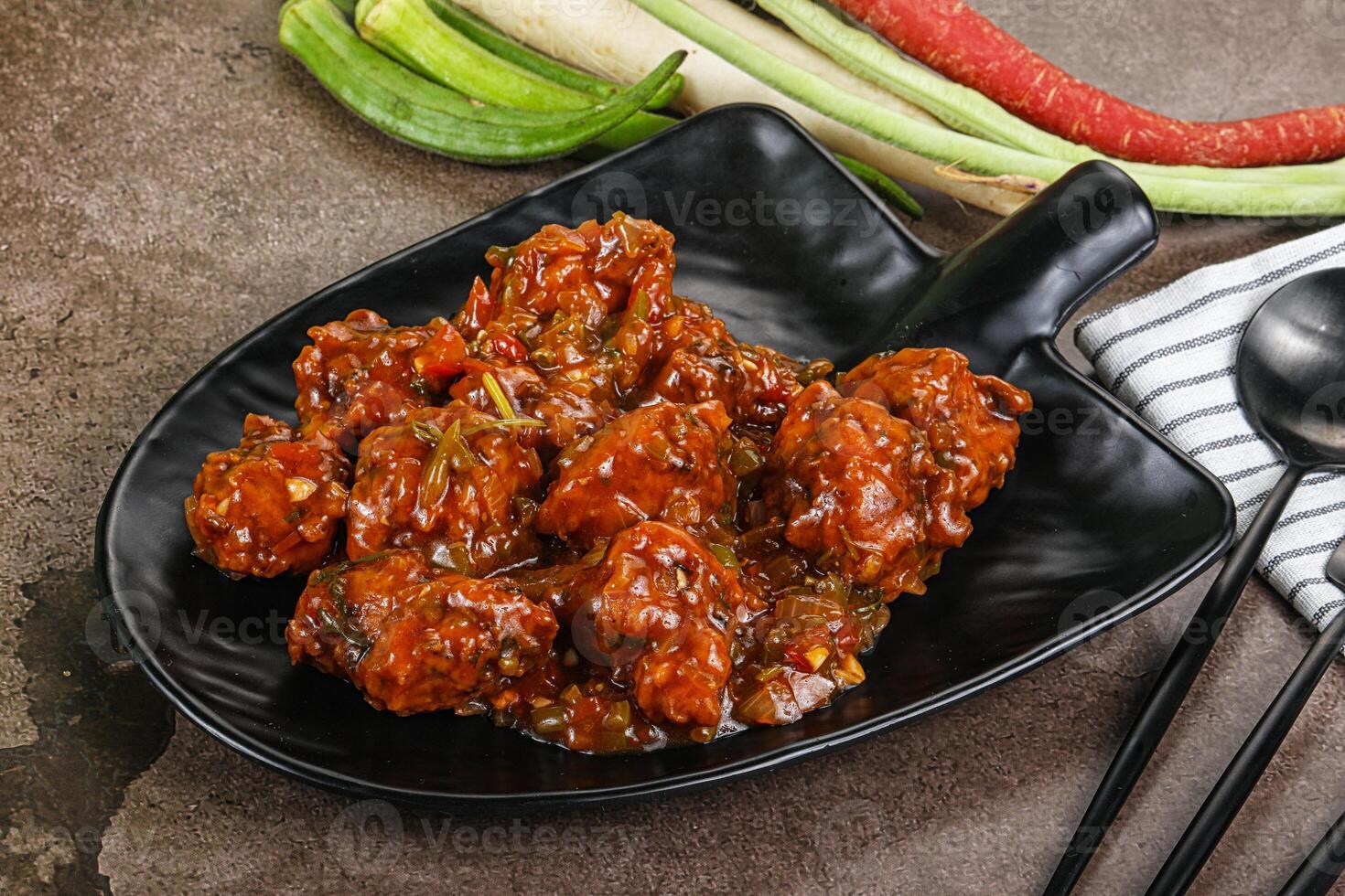 Manchurian chicken with sauce and spices photo