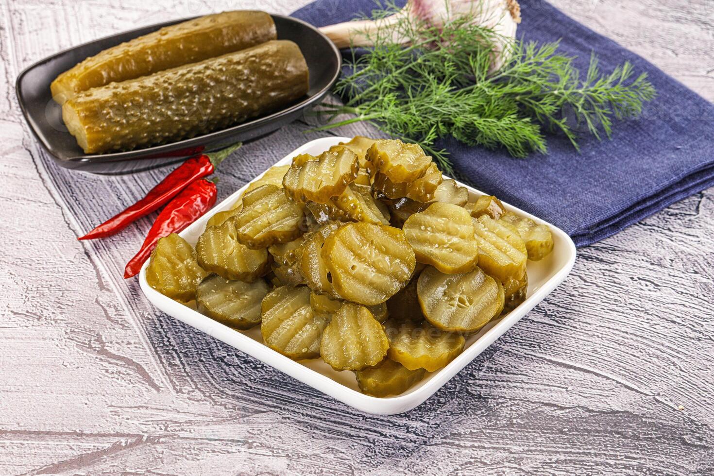 Sliced marinated cucumbers in the bowl photo