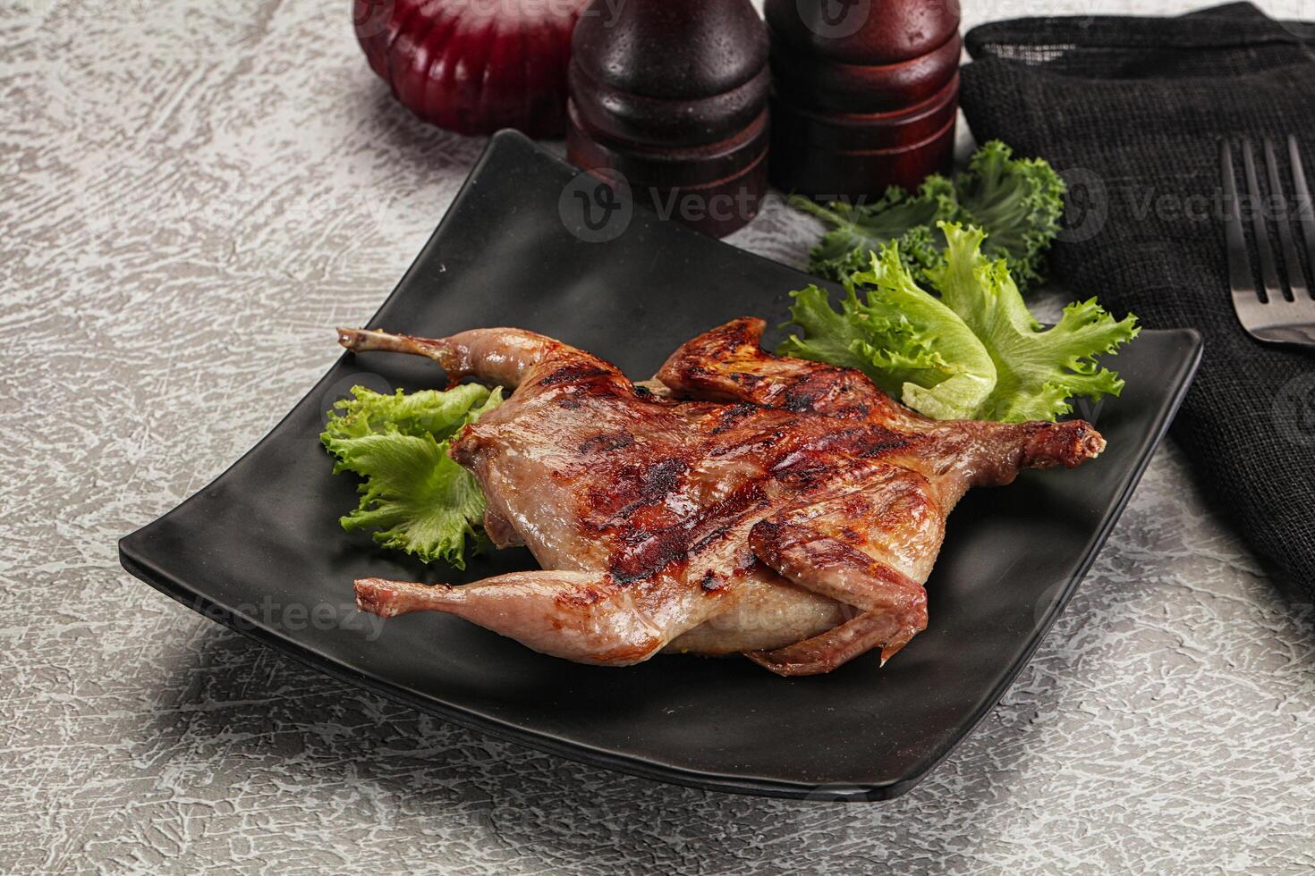 Grilled quail in the plate photo