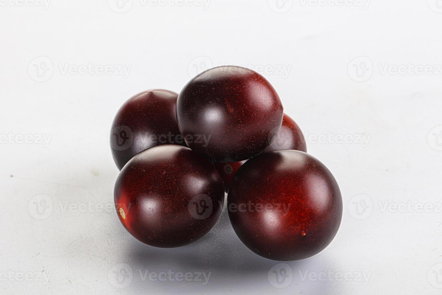 Raw ripe black kumato tomato photo
