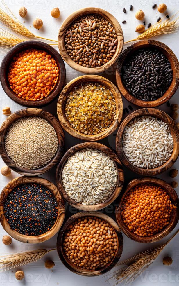 A variety of different colored rice and beans are displayed in wooden bowls. The bowls are arranged in a row, with some bowls containing more beans than rice photo