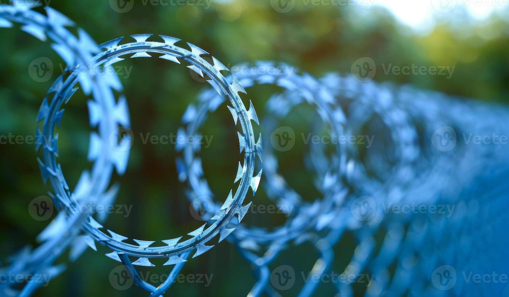 A fence with a wire mesh and barbed wire photo