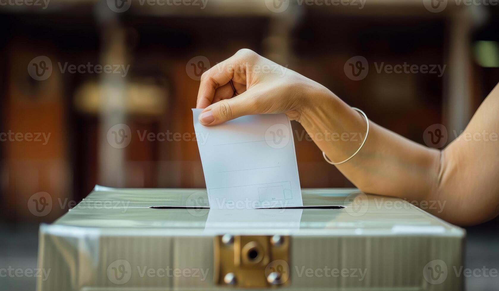 A person is putting a piece of paper into a box. The person is likely voting in an election photo