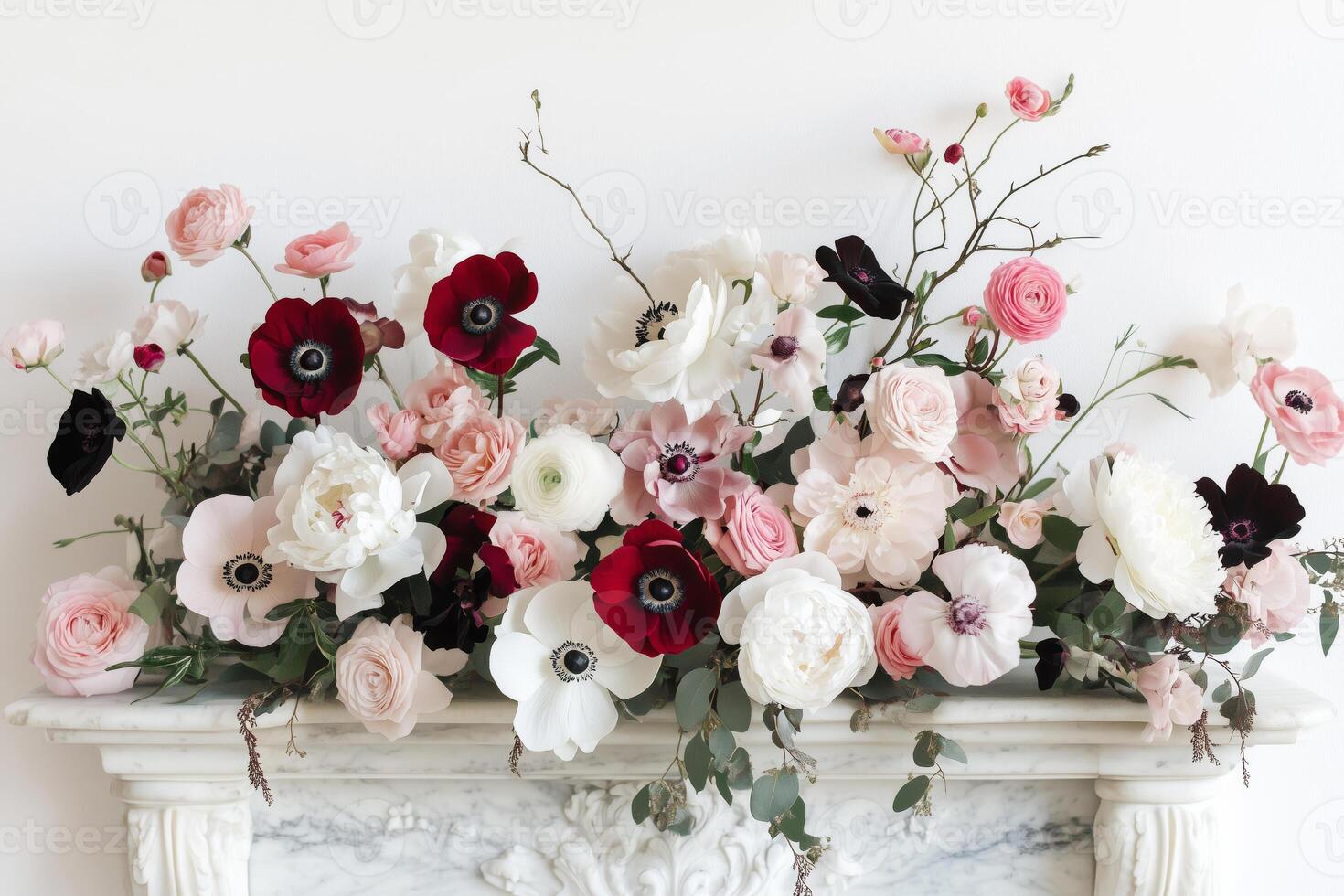Floral arrangement of white, pink and red roses, peonies and anemones on the mantelpiece photo