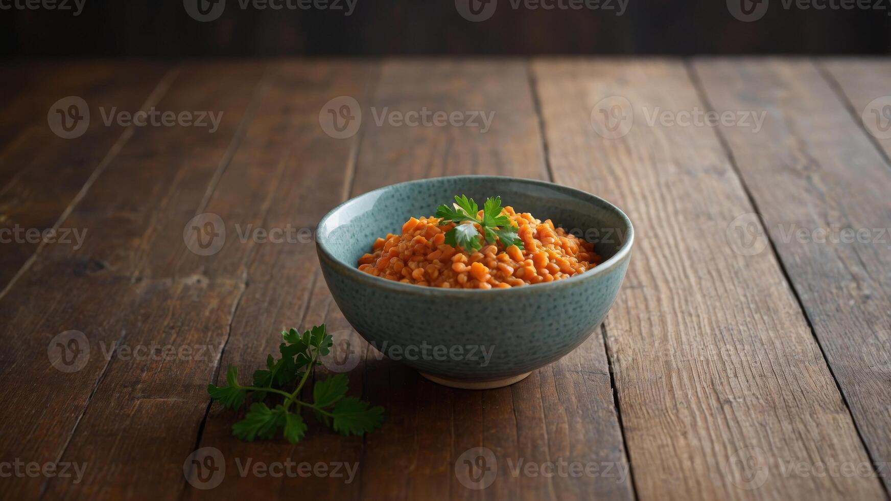 Red lentil bowl arranged on a wooden surface with copy space image. photo