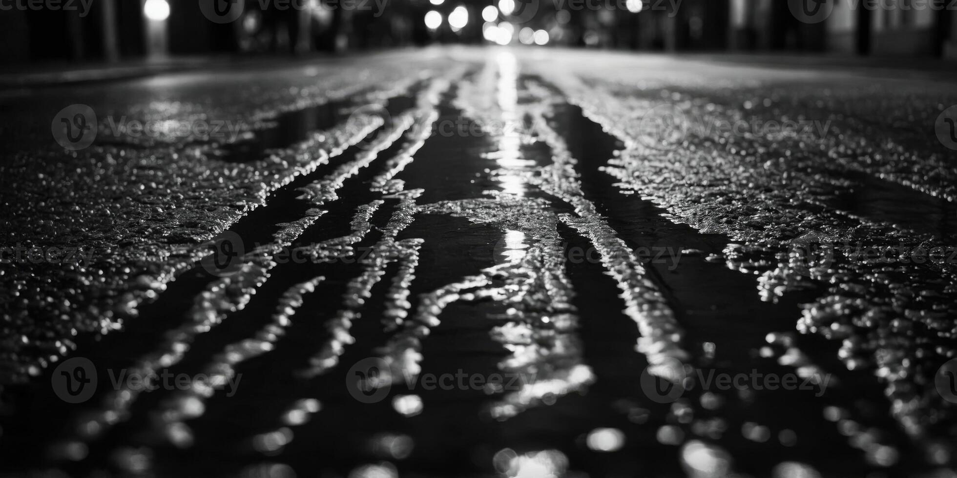 The glowing lights of the city create a shimmering effect in a puddles reflection Black and white art. photo