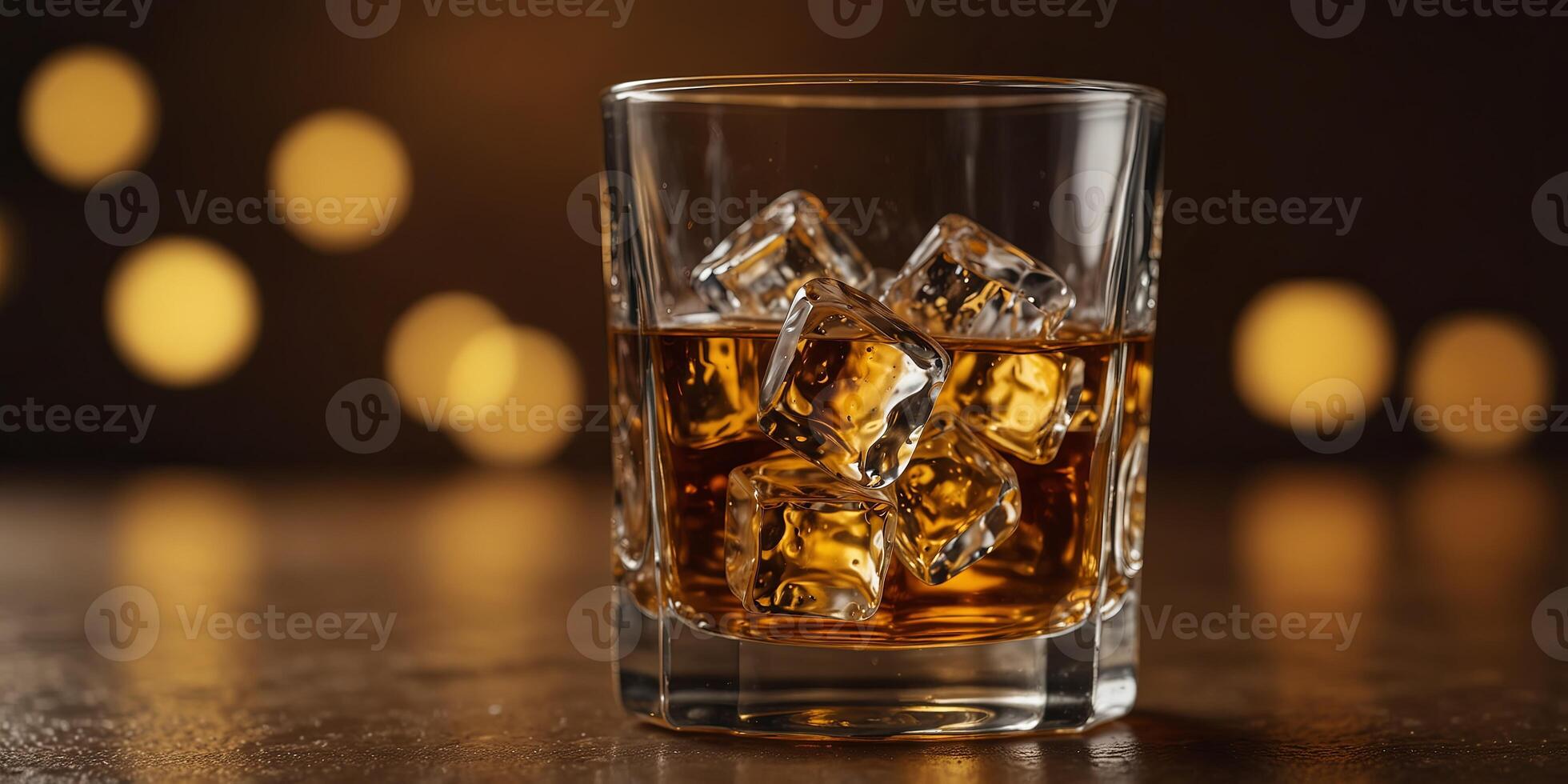Glass of whiskey with ice cubes on amber background, minimalist composition Beverage and relaxation concept. photo
