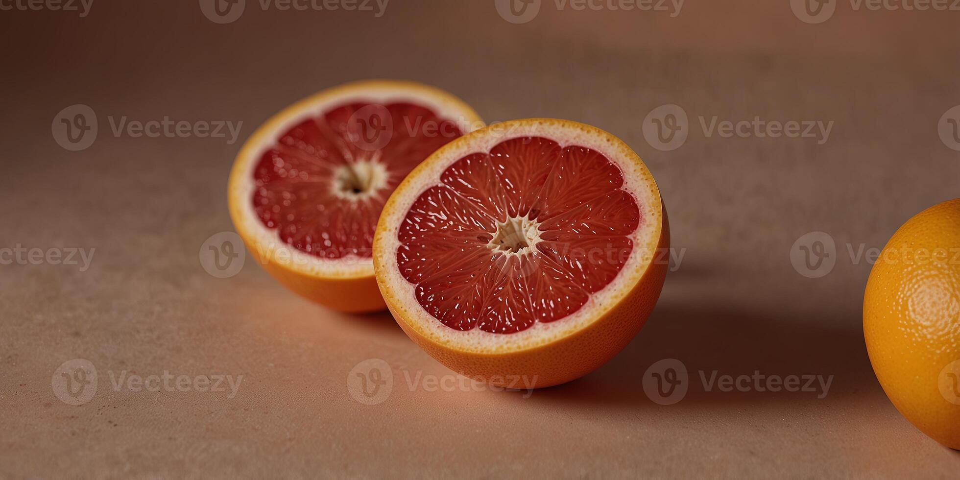 Grapefruit halves on a peach background, minimalistic and fresh Healthy eating concept. photo