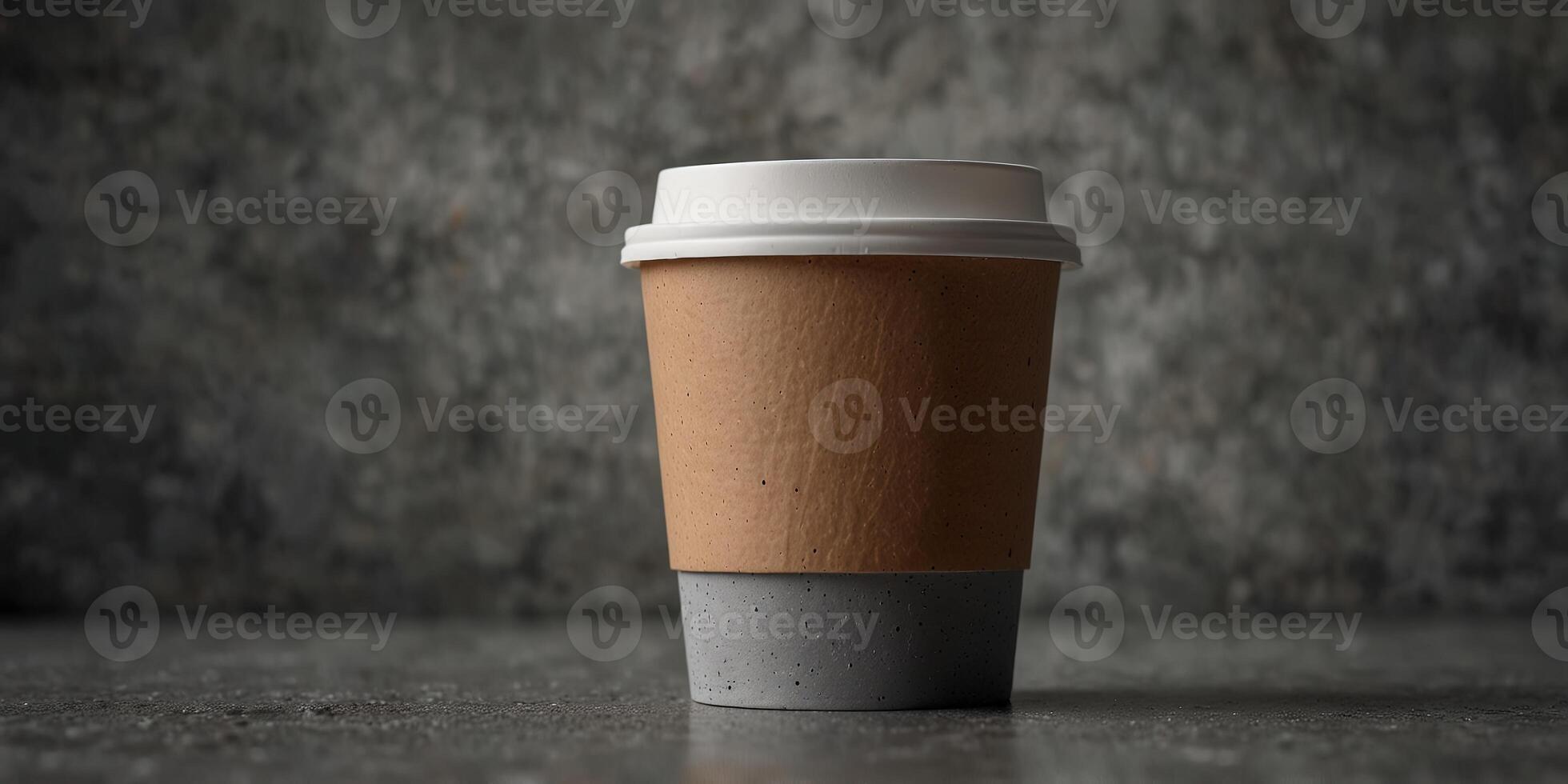 Gray concrete background with a blank take away coffee paper cup featuring ample copy space image. photo